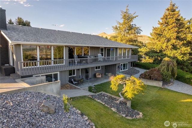 3418 Mari Lane Dr, Wenatchee, WA 98801 - rear view of property featuring a patio area, a lawn, a shingled roof, and a wooden deck