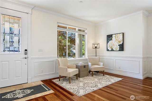 17445 NE 28th St, Redmond, WA 98052 - living area with wood finished floors, crown molding, a decorative wall, and wainscoting