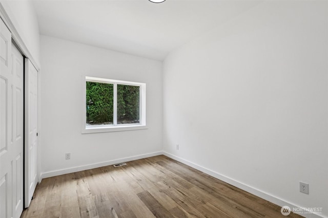 2805 Chambers Bay Dr, Steilacoom, WA 98388 - unfurnished bedroom with wood finished floors and a closet