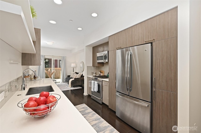 8505A 14th Ave NW, Seattle, WA 98117 - kitchen with appliances with stainless steel finishes, light countertops, recessed lighting, decorative backsplash, and dark wood-type flooring