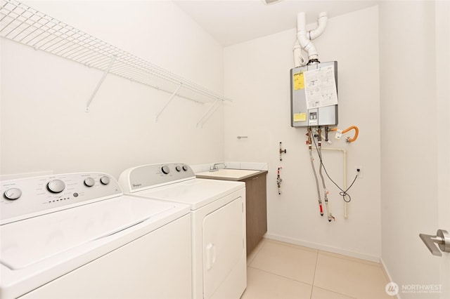 8505A 14th Ave NW, Seattle, WA 98117 - laundry room with cabinet space, washing machine and clothes dryer, light tile patterned floors, and tankless water heater