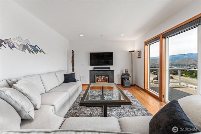 582 Lower Daniels Dr, East Wenatchee, WA 98802 - living room featuring wood finished floors, recessed lighting, and a tiled fireplace