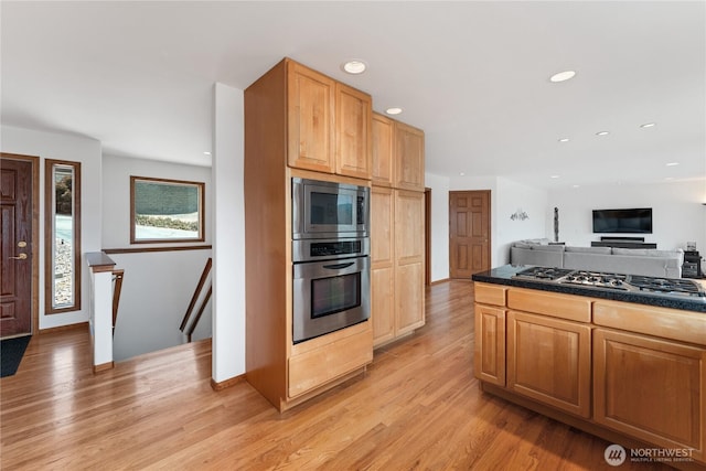 582 Lower Daniels Dr, East Wenatchee, WA 98802 - kitchen with appliances with stainless steel finishes, dark countertops, light wood-type flooring, open floor plan, and recessed lighting