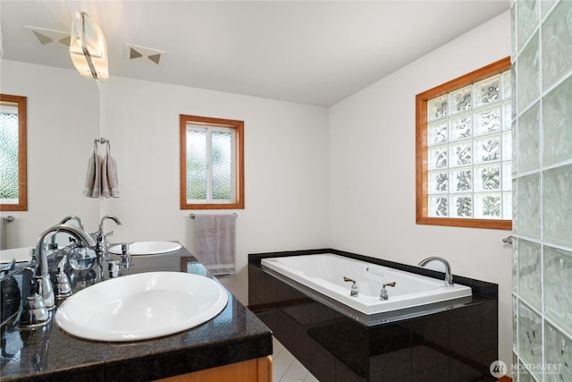 582 Lower Daniels Dr, East Wenatchee, WA 98802 - bathroom featuring a garden tub, double vanity, and tile patterned floors