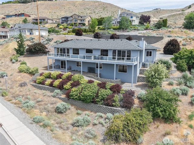582 Lower Daniels Dr, East Wenatchee, WA 98802 - rear view of property with a mountain view, a residential view, and a chimney