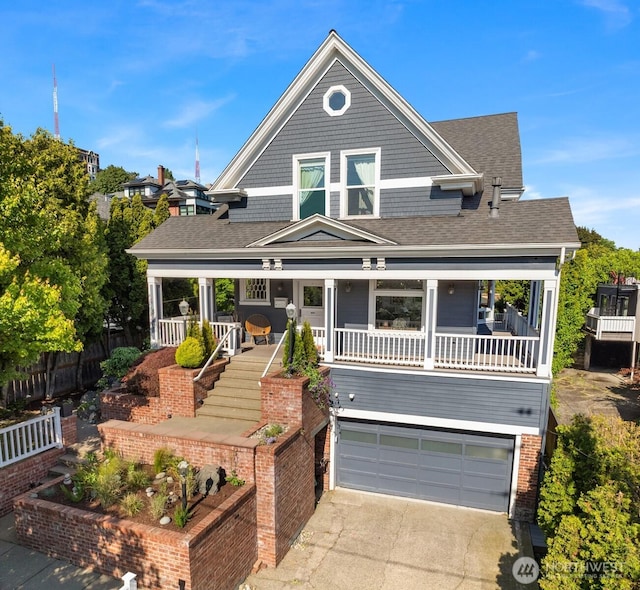 1012 2nd Ave W, Seattle, WA 98119 - view of front of property featuring a garage, concrete driveway, covered porch, and a shingled roof