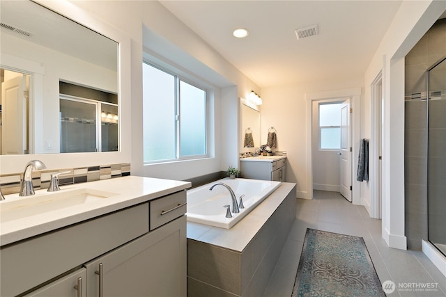 3359 Terry Ln, Enumclaw, WA 98022 - full bathroom with a shower stall, tile patterned flooring, two vanities, a garden tub, and recessed lighting