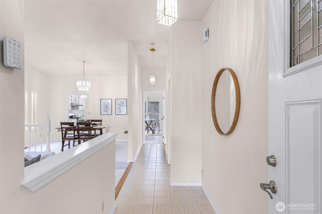 7969 W Golf Course Dr, Birch Bay, WA 98230 - hallway with a chandelier and light tile patterned floors