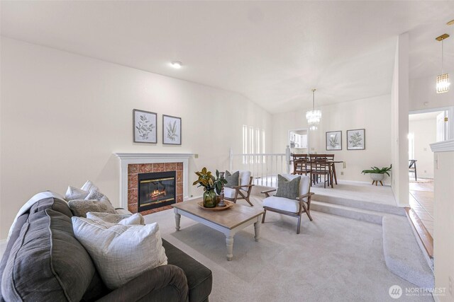 7969 W Golf Course Dr, Birch Bay, WA 98230 - living area featuring light carpet, a fireplace, and a chandelier