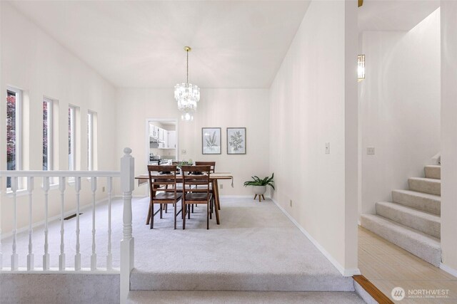 7969 W Golf Course Dr, Birch Bay, WA 98230 - carpeted dining area featuring stairs and a chandelier