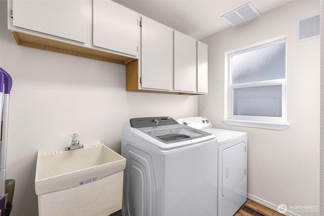 7969 W Golf Course Dr, Birch Bay, WA 98230 - laundry area featuring washing machine and clothes dryer and cabinet space