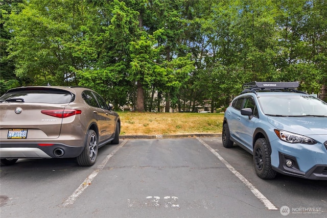 5300 Harbour Pointe Blvd Unit 302G, Mukilteo, WA 98275 - uncovered parking lot featuring view of scattered trees