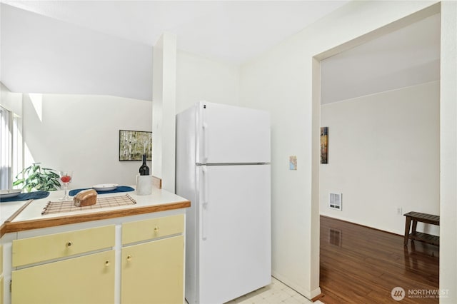 12613 SE 42nd St Unit 613, Bellevue, WA 98006 - kitchen with freestanding refrigerator, light countertops, cream cabinetry, and light wood-style flooring