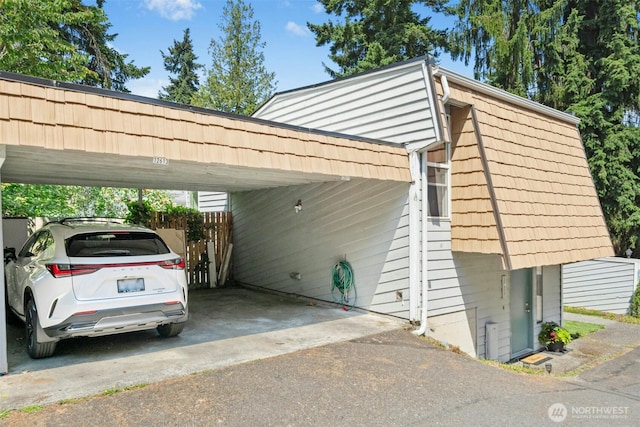 12613 SE 42nd St Unit 613, Bellevue, WA 98006 - view of vehicle parking featuring driveway and a carport