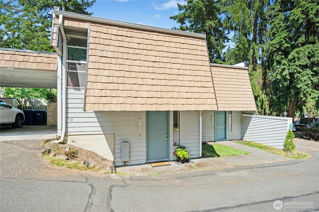 12613 SE 42nd St Unit 613, Bellevue, WA 98006 - view of front of property featuring mansard roof, asphalt driveway, and an attached carport
