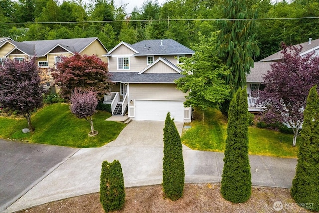 14926 Woodland Ave E, Puyallup, WA 98375 - view of front of property featuring concrete driveway, a front lawn, a garage, and roof with shingles