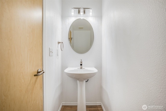 14926 Woodland Ave E, Puyallup, WA 98375 - bathroom featuring wood finished floors and baseboards