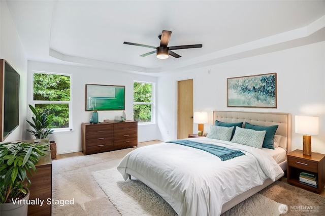 14926 Woodland Ave E, Puyallup, WA 98375 - bedroom with a tray ceiling, multiple windows, and ceiling fan