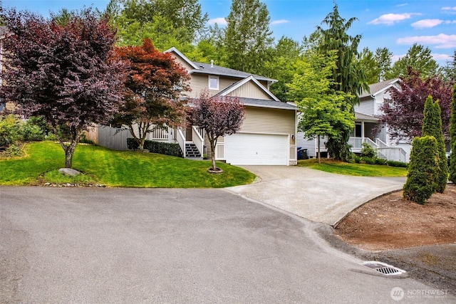 14926 Woodland Ave E, Puyallup, WA 98375 - view of property hidden behind natural elements featuring concrete driveway, a front lawn, stairs, and a garage
