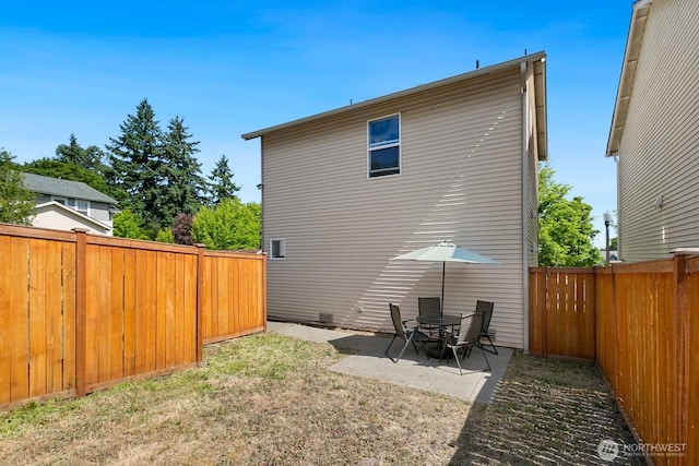 1736 E 39th St, Tacoma, WA 98404 - back of house with a fenced backyard and a patio