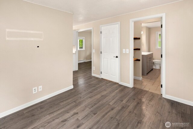 14226 44th St NE, Lake Stevens, WA 98258 - empty room featuring dark wood-style flooring, plenty of natural light, baseboard heating, and crown molding