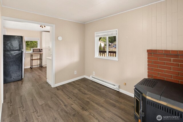 14226 44th St NE, Lake Stevens, WA 98258 - unfurnished living room with a baseboard radiator, dark wood-style floors, plenty of natural light, and crown molding