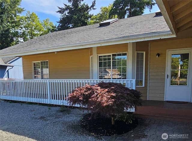 24827 36th Ave E, Spanaway, WA 98387 - view of exterior entry featuring roof with shingles and covered porch