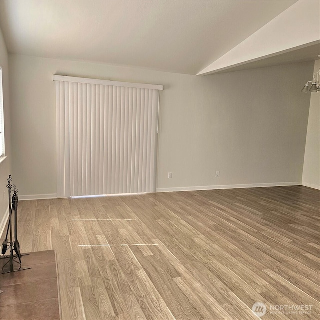24827 36th Ave E, Spanaway, WA 98387 - unfurnished living room featuring wood finished floors and lofted ceiling