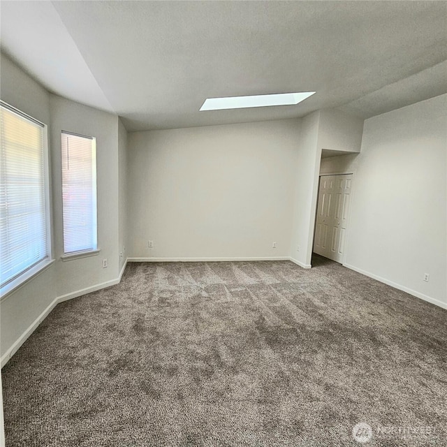 24827 36th Ave E, Spanaway, WA 98387 - unfurnished bedroom with a skylight, carpet floors, and vaulted ceiling