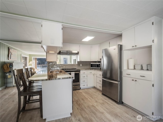 7217 20th Ave SE, Lacey, WA 98503 - kitchen with appliances with stainless steel finishes, light wood-type flooring, white cabinets, and decorative backsplash