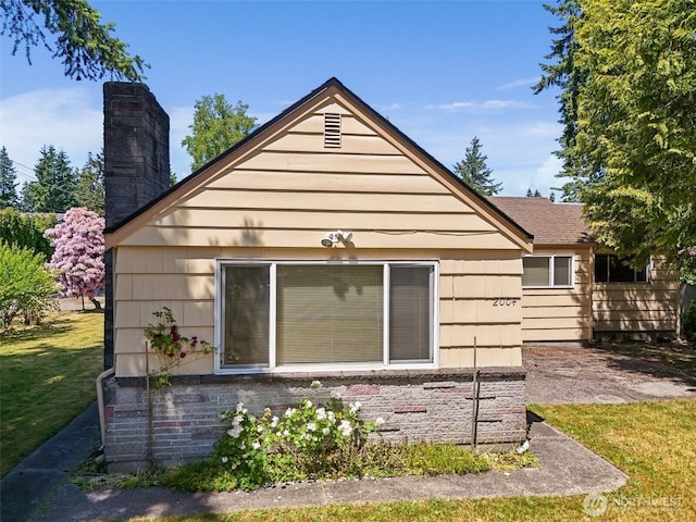 2004 N 143rd St, Seattle, WA 98133 - view of side of property featuring a chimney and a yard