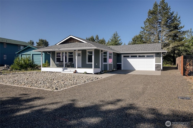 213 N Wynoochee Dr SW, Ocean Shores, WA 98569 - view of front of home featuring covered porch, an attached garage, driveway, and a shingled roof