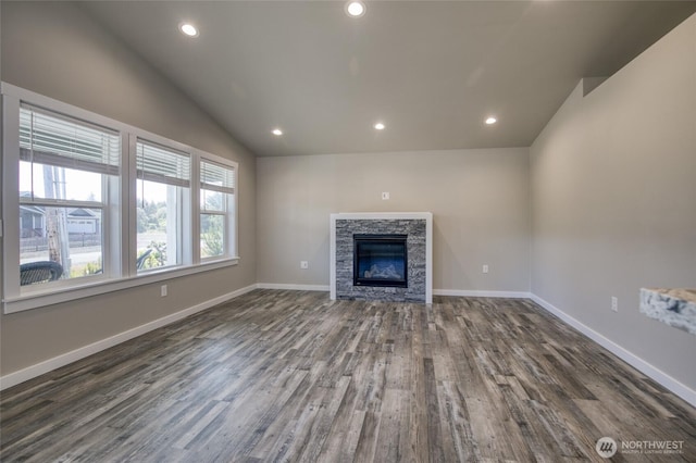 213 N Wynoochee Dr SW, Ocean Shores, WA 98569 - unfurnished living room with vaulted ceiling, dark wood finished floors, recessed lighting, baseboards, and a stone fireplace