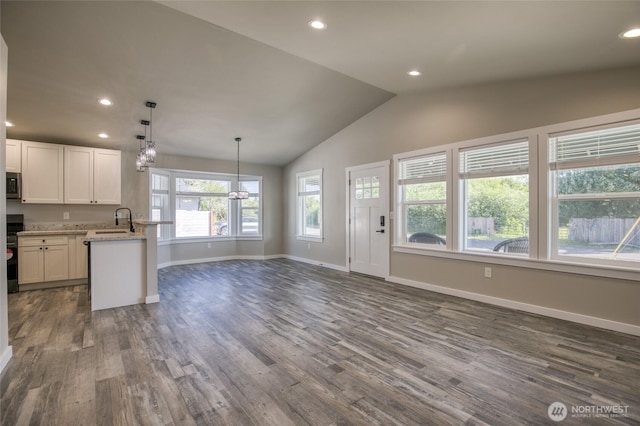 213 N Wynoochee Dr SW, Ocean Shores, WA 98569 - kitchen featuring a chandelier, dark wood-style floors, stainless steel appliances, white cabinetry, and vaulted ceiling