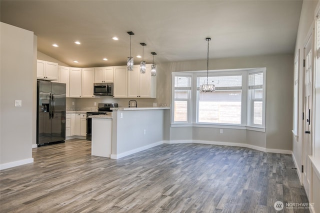 213 N Wynoochee Dr SW, Ocean Shores, WA 98569 - kitchen featuring appliances with stainless steel finishes, light countertops, wood finished floors, baseboards, and recessed lighting