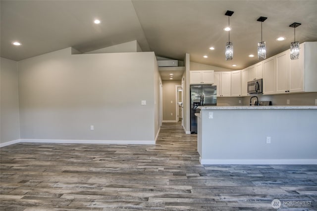 213 N Wynoochee Dr SW, Ocean Shores, WA 98569 - kitchen with stainless steel microwave, fridge with ice dispenser, white cabinets, dark wood finished floors, and lofted ceiling