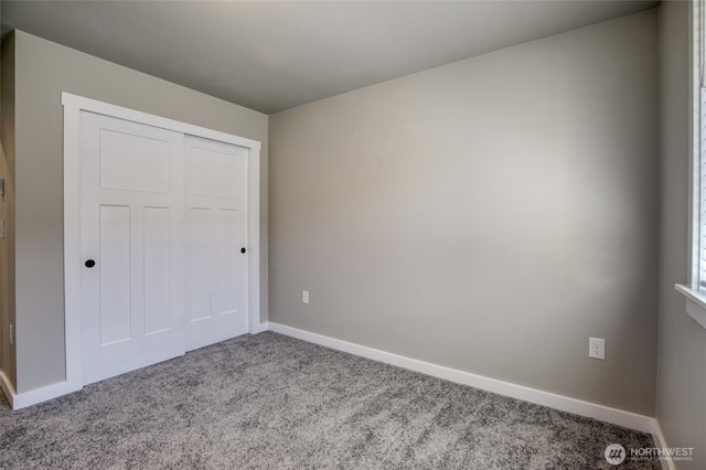 213 N Wynoochee Dr SW, Ocean Shores, WA 98569 - unfurnished bedroom with carpet floors, baseboards, and a closet