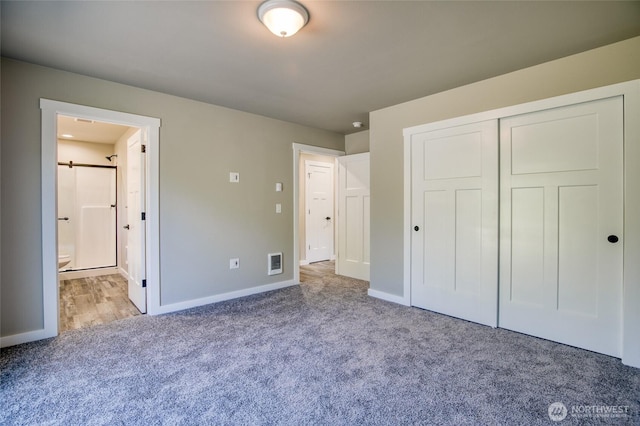 213 N Wynoochee Dr SW, Ocean Shores, WA 98569 - unfurnished bedroom featuring carpet floors, ensuite bath, baseboards, and a closet