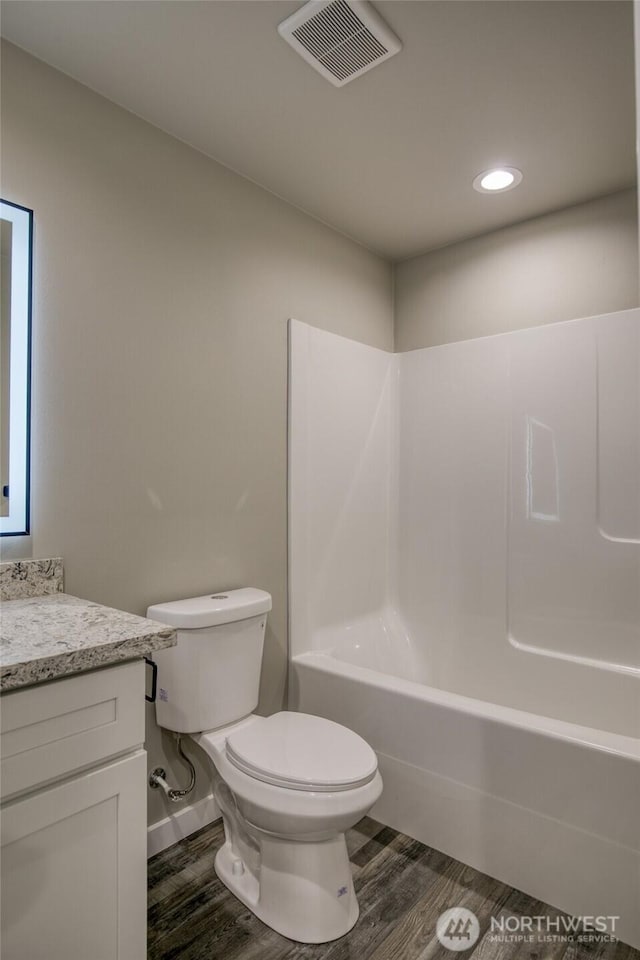 213 N Wynoochee Dr SW, Ocean Shores, WA 98569 - bathroom featuring vanity, wood finished floors, toilet, shower / bathtub combination, and recessed lighting