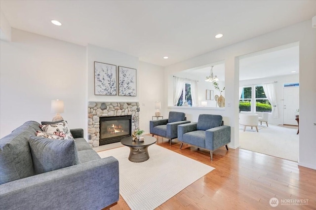 15204 48th Ave SE, Everett, WA 98208 - living area with a stone fireplace, light wood-type flooring, a chandelier, and recessed lighting