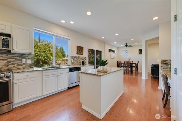 15204 48th Ave SE, Everett, WA 98208 - kitchen with appliances with stainless steel finishes, tasteful backsplash, white cabinetry, a center island, and recessed lighting