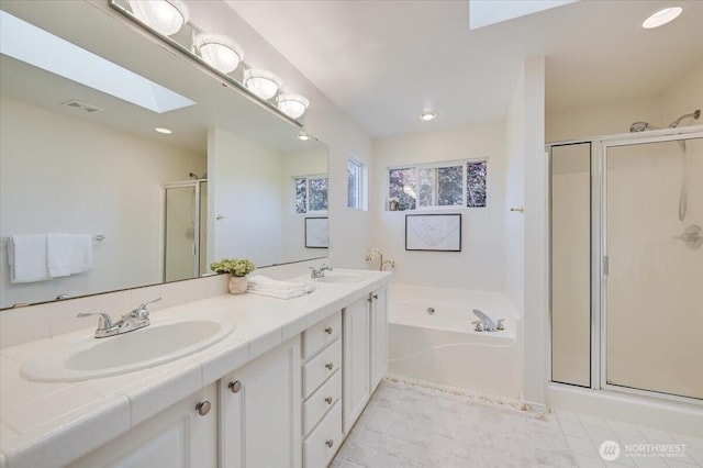 15204 48th Ave SE, Everett, WA 98208 - full bathroom featuring a skylight, a shower stall, a garden tub, double vanity, and recessed lighting