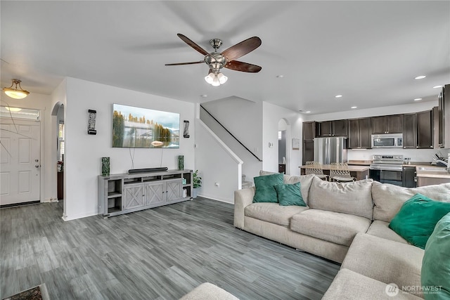 17712 17th Ave E, Spanaway, WA 98387 - living room featuring arched walkways, ceiling fan, stairway, recessed lighting, and wood finished floors