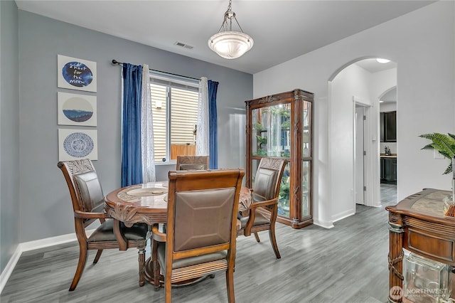 17712 17th Ave E, Spanaway, WA 98387 - dining room featuring arched walkways and wood finished floors