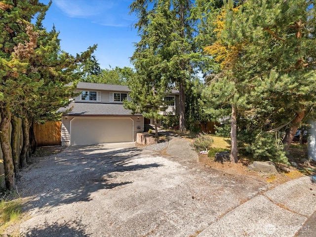 10122 50th Pl W, Mukilteo, WA 98275 - obstructed view of property with gravel driveway, a garage, and a shingled roof