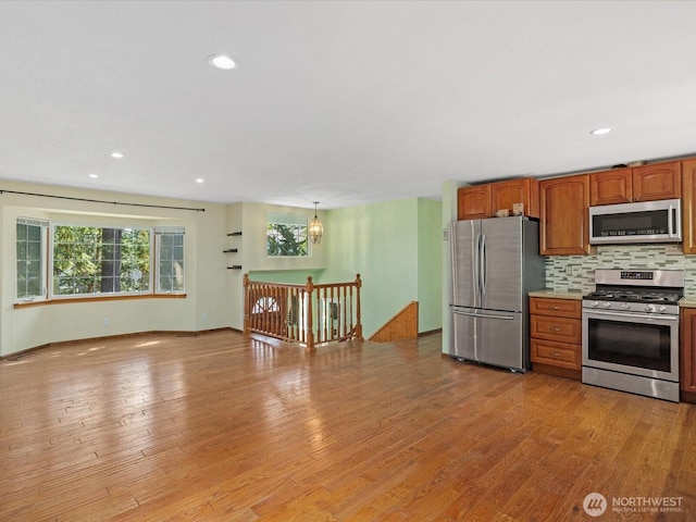 10122 50th Pl W, Mukilteo, WA 98275 - kitchen featuring stainless steel appliances, tasteful backsplash, light wood-type flooring, light countertops, and recessed lighting