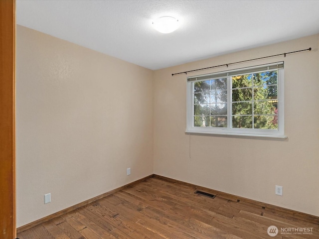10122 50th Pl W, Mukilteo, WA 98275 - empty room featuring wood finished floors and baseboards