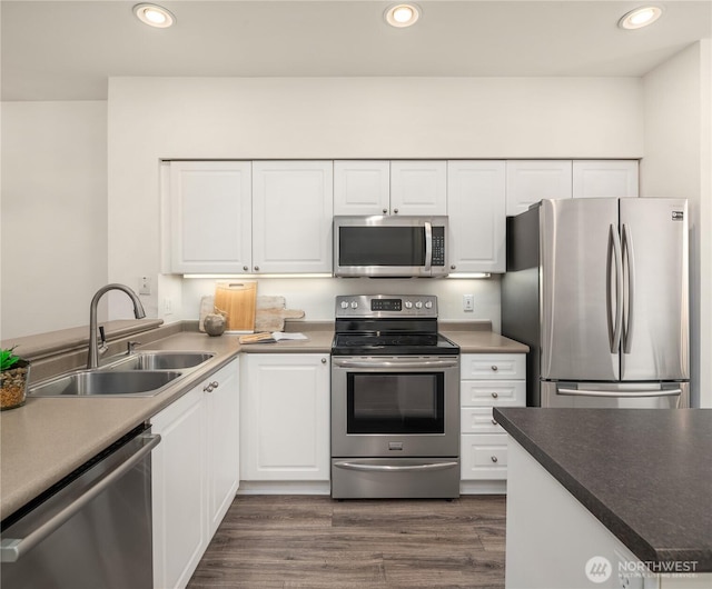 16125 Juanita Woodinville Way NE Unit 1807, Bothell, WA 98011 - kitchen featuring appliances with stainless steel finishes, white cabinetry, recessed lighting, and dark wood-type flooring