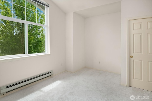 16125 Juanita Woodinville Way NE Unit 1807, Bothell, WA 98011 - carpeted empty room with a baseboard radiator and plenty of natural light
