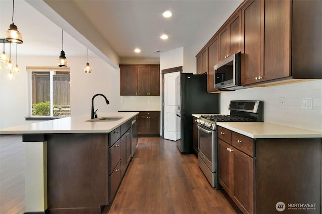 17723 3rd Ave SE, Bothell, WA 98012 - kitchen featuring appliances with stainless steel finishes, backsplash, light countertops, an island with sink, and recessed lighting